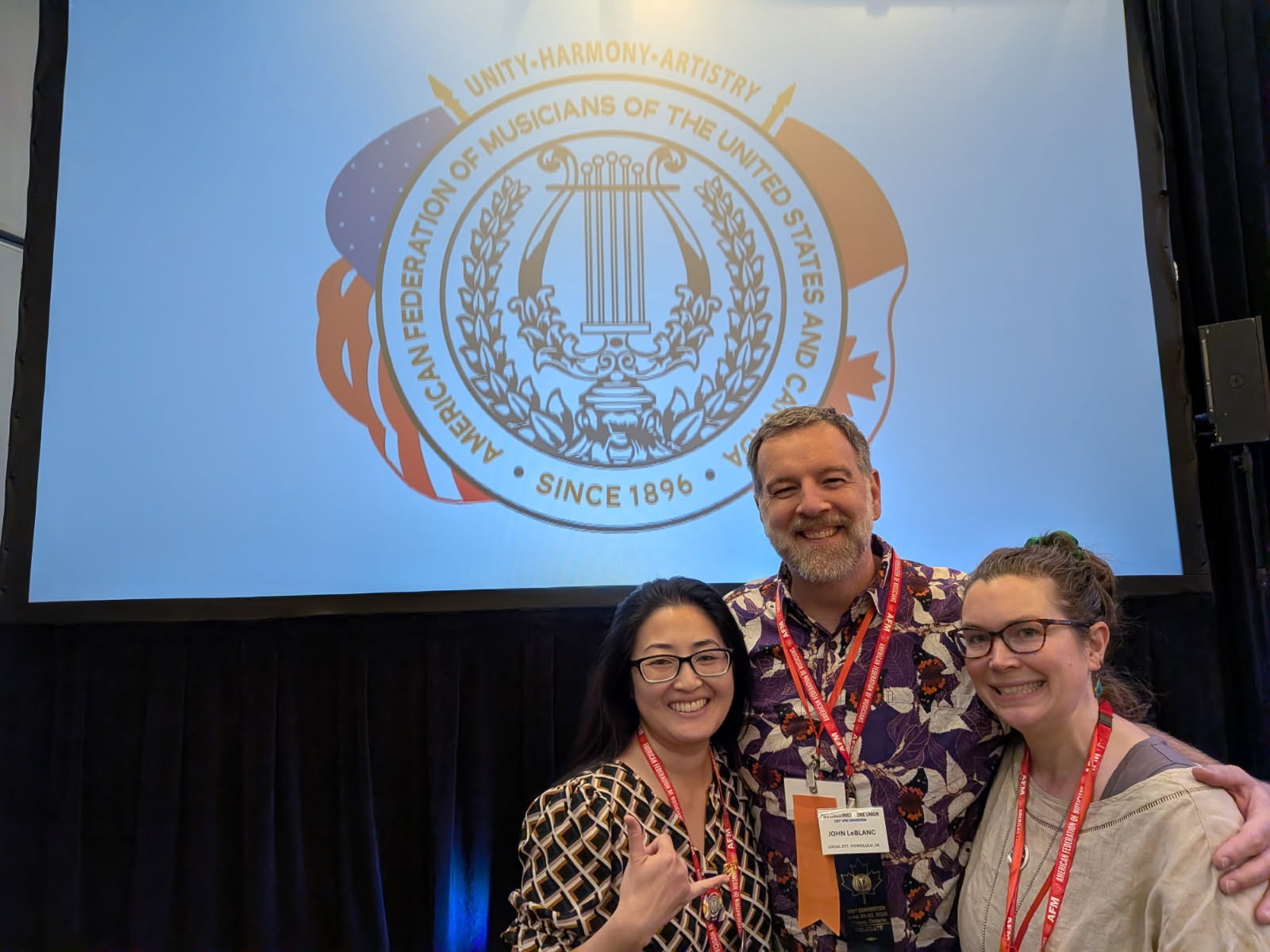 Rebecca Matayoshi, John LeBlanc and Dana Rokosny beneath the AFM seal